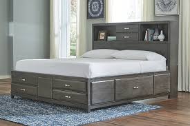 Beds mattresses mattress toppers under bed storage bedside tables wardrobes chests of drawers mirrors bedding quilt cover sets blankets & throws bedroom inspiration for every taste. Caitbrook Queen Storage Bed With 8 Drawers Ashley Furniture Homestore