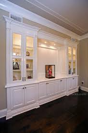 Lighted With Simple Trim And Classic Effects Like The Glassed Enclosure To Keep Books Clean Living Room Built Ins Built In Wall Units Room Remodeling