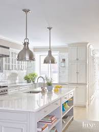 Completely White Kitchen With Chrome Pendant Lighting And Book Shelf Storage Luxury Kitchens Small American Kitchens Luxury Kitchen Design