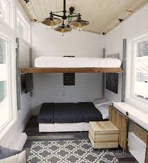 Chaise lounge sofa in living room under tiny house loft bedroom; Genius Tiny House Is Full Of Diy Transforming Furniture Curbed