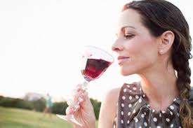 Italy, Tuscany, Siena, young woman drinking red wine in a vineyard at  sunset stock photo