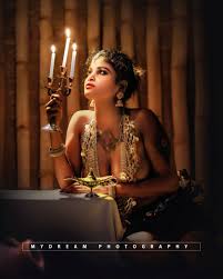 Dhanya Nath posing topless but hides her topless big milkers with jewellery  and holding candles