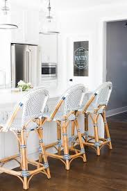 Black And White Counter Stools Serena Lily Riviera Counter Stools Sit On A Dark Stained Oak Floor In Front Of An All White Kitc Kitchen Interior Design Modern Modern Kitchen Interiors Home