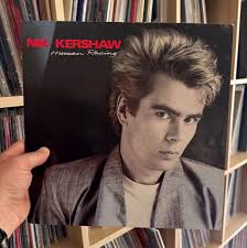 Wouldn't It Be Good" To play some Nik Kershaw for a while. Maybe Human  Racing from 1984. would be a good ide.