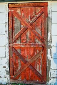 Barn doors are quite versatile and can be used in any type of rooms. Old Red Barnwood Door With Peeling Paint In The Daylight Red Barn Door Barnwood Doors Interior Barn Doors