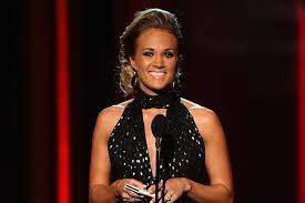 Carrie underwood dark pink cocktail dress and lose ponytail hairstyle. Carrie Underwood Debuts Brunette Ish Hair Style