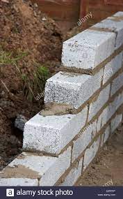 Download This Stock Image Bricklaying Wall With Half Cement Breeze Blocks Building A Block Retaining Wall In The Uk C2pf Breeze Blocks Retaining Wall Breeze