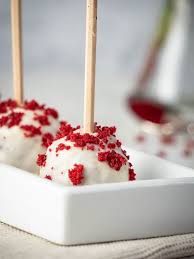 Now, dip a popsicle stick into the chocolate just to coat a bit of the bottom. Red Velvet White Chocolate Cake Pops In The Kitch