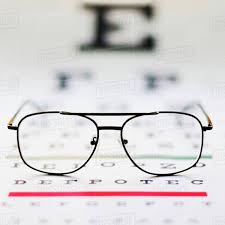 Close Up Of Glasses On Eye Chart Studio Shot D1028_29_361