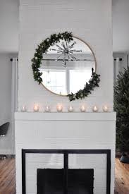 Many home decorators like to hang up mirrors in order to increase the amount of light in a room and to make the space appear larger than it really is. Diy Modern Asymmetrical Holiday Wreath On A Round Mirror