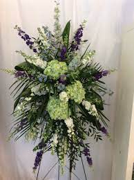 Standing flower arrangements are typically oval in shape. Standing Funeral Spray By Petalos Floral