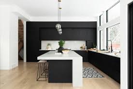 The rich black stain on these cabinets emphasizes the clean lines, sleek hardware, and beautiful wood grain. How To Use Black For Kitchen Cabinetry Making Your Home Beautiful