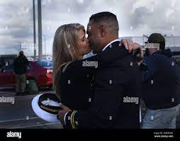 SAN DIEGO (March 4, 2022) Lt. j.g. Donny Rettew, from Greenville, S.C.,  kisses his partner after completing a seven-month deployment aboard  amphibious assault ship USS Essex (LHD 2). Essex, a part of