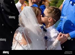 Cute little boy kisses the bride at the wedding Stock Photo - Alamy