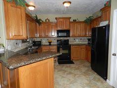 The Tomball Magnolia Housing Scene Trendy Kitchen Tile Black Appliances Kitchen Best Kitchen Cabinets
