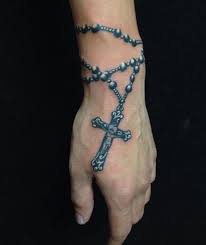Rosary tattoos depicting rosaries and simple christian church on the hands of praying person are the symbols of great and devoted belief and love to god. Rosary Wrist Tattoos For Men Cute Simple Tattoos