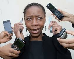 A Woman Attempting To Juggle Too Many Mobile Phones