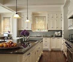 Traditional kitchen brown cabinet black countertop. Cream Kitchen Cabinets With Black Countertops Lighting With Black Lines Ivory Kitchen Cabinets Home Kitchens Ivory Kitchen