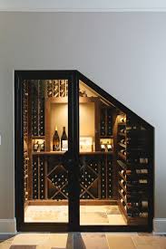 The lighting and wine within an arched style creates a shining ambience. 0021 Willett Handcrafted Basement 05102016 20160510 Jpg 3 000 4 500 Pixel Under Stairs Wine Cellar Home Wine Cellars House Design