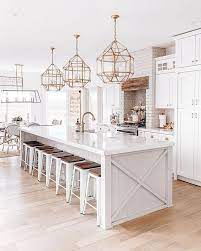 White Kitchen Coastal Farmhouse Kitchen Brass Gold Light Fixtures Big Kitchen Island Coastal Farmhouse Kitchen Home Decor Kitchen Home Kitchens