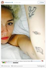 On the sides of her fingers are an equal sign, a peace symbol, a cross, bad from the michael. Miley Cyrus Saturn Tattoo She S Not Wrong Time