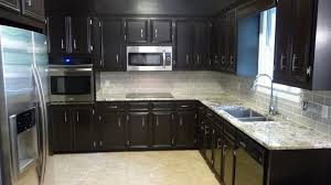 Kitchens with black granite countertop surfaces are trending as beautiful and has a sleek and stylish look. Light Colored Tile Backsplash Ideas With Dark Cabinets Dark Cherry Cabinet With White Ba Backsplash With Dark Cabinets Unique Kitchen Backsplash Kitchen Design