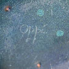 A multicoloured enameled copper plate