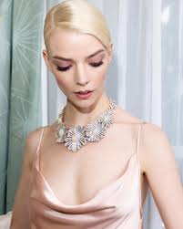 Behind the scenes with Anya Taylor-Joy as she prepares to attend the 82nd  annual Golden Globe Awards. Anya wears the Blue Book 2024: Tiffany Céleste  Star Burst Crystal Opal necklace in platinum