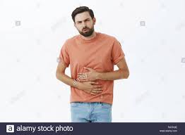 Maybe you would like to learn more about one of these? Homme Gene Dans L Estomac De Manger Fast Food Tenant Les Mains Sur Ventre Dur Sur L Expiration Et De La Douleur Grimacant Avoir La Diarrhee Ou D Estomac Stan Photo Stock Alamy