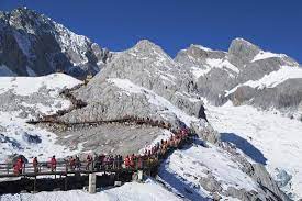 According to naxi nationality's legend, it is the embodiment of sanduo, the god of naxi ethnic group. Tourists On Jade Dragon Snow Mountain Yulong Xueshan Lijiang Yunnan China Asia Photographic Print Ian Trower Art Com