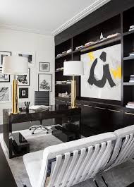 Contemporary Home Office With Espresso Built Ins Contemporary Den Library Office Contemporary home office features a glossy brown lacquered greek key desk topped with tall brass lamps facing a pair of white barcelona chairs atop a light gray rug placed next to a full wall lined with. office with espresso built ins