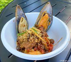 Spoon 1/2 cup couscous in center of each plate. Moroccan Seafood Couscous With Shrimp Mussels Olives Preserved Lemons And Anchovy Breadcrumbs Taste Of Marrakesh 2021 Epcot Flower And Garden Festival Allears Net