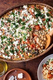 Couscous with chickpeas, fennel, and citrus. Pearl Couscous With Creamy Feta And Chickpeas Recipe Recipe Vegetarian Recipes Chickpea Recipes Couscous Recipes