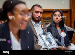 Felix Rubio, center, and Kimberly Rubio, right, whose daughter Alexandria  Rubio was one of the children killed by a gunman at Robb Elementary School  in Uvalde, Texas, listen to remarks by Kelly