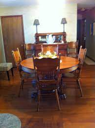 She found four of these bad boys for only $20. 150 Year Old Family Antique Round Oak Claw Foot Table And Chairs Round Dining Room Family Dining Rooms Round Dining Room Table