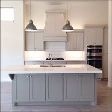 The cloud white kitchen island and perimeter cabinets blend seamlessly with the white subway tile backsplash, while the small area of wall painted in benjamin moore silver satin adds just the right amount of dimension to the space. Kendall Charcoal Benjamin Moore Chelsea Gray Novocom Top