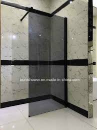 A shower wall panel or surround differs from that of a tub system in that it is a longer design, meant to reach all the way down to and integrate with the shower base. China Matt Black Wetroom Panel 8mm Safety Smoked Glass Shower Wall China Wetroom Panel Shower Wall