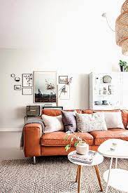 Colorful pillows covering the sofa softens the furniture's rough and rugged good looks. 45 Refined Orange Sofas For A Bold Color Statement Digsdigs