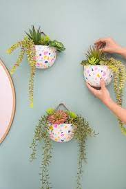 wall decor meets gardening and it s all thanks to this faux terrazzo hanging planter with a fun colorful painted pots diy flower plant sloth succulent holder