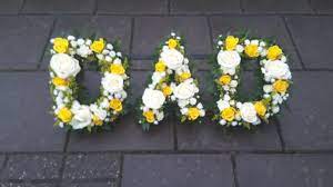 A blue and white floral wreath suitable for the passing of a. Dad In White And Yellow Flowers With A Greenery Edge In 2021 Funeral Flower Arrangements Florist London Funeral Flowers
