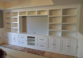 Use 2 x 3's to make a large rectangle that will fit along the entire base of the cabinets. Entertainment Center Bookshelves Ideas On Foter