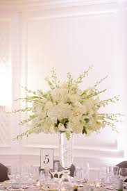 The tall centerpieces included hydrangea, orchids and calla lilies. Tall Orchid Bouquet Flower Centerpieces Wedding Calla Lily Wedding Arrangements White Wedding Centerpieces