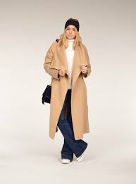 It's time to put away our heavy coats and slowly transition into sweater weather. The Story Of The Camel Coat