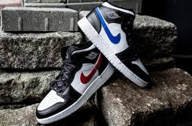 Black White Jordan 1 Mid Mismatching Swooshes Land On The Air Jordan 1 Mid Gs Black Multicolor The Air Jordan 1 Mid Gs Is Back In A New Air Jordans Trending Shoes Jordan 1 Mid