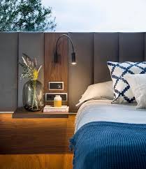 An Upholstered Headboard Lines The Walls Of This Bedroom In 2020 Gray Master Bedroom Upholstered Headboard Headboard