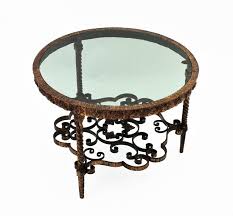 The design has two tiers. Wrought Gilt Iron Smoked Glass Round Coffee Table Twisted Legs And Floral Motif For Sale At 1stdibs