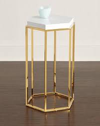 This modern side table deserves to be on the red carpet because of its sleek, glamorous frame. Adley Gold And White Side Table
