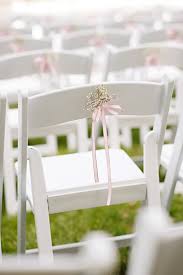 Simple Touches Like Baby S Breath And Ribbon Can Dress Up A Ceremony Chair Wedding Chair Decorations White Folding Chairs White Wooden Chairs