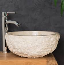 cream stone sink. rough round marble