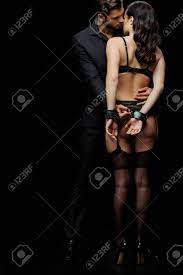 Submissive Woman In Underwear And Handcuffs Standing With Man Isolated On  Black Stock Photo, Picture and Royalty Free Image. Image 135707827.